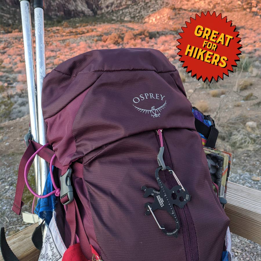 Maroon Osprey backpack with hiking gear in a desert setting, featuring a 'Great for Hikers' badge.