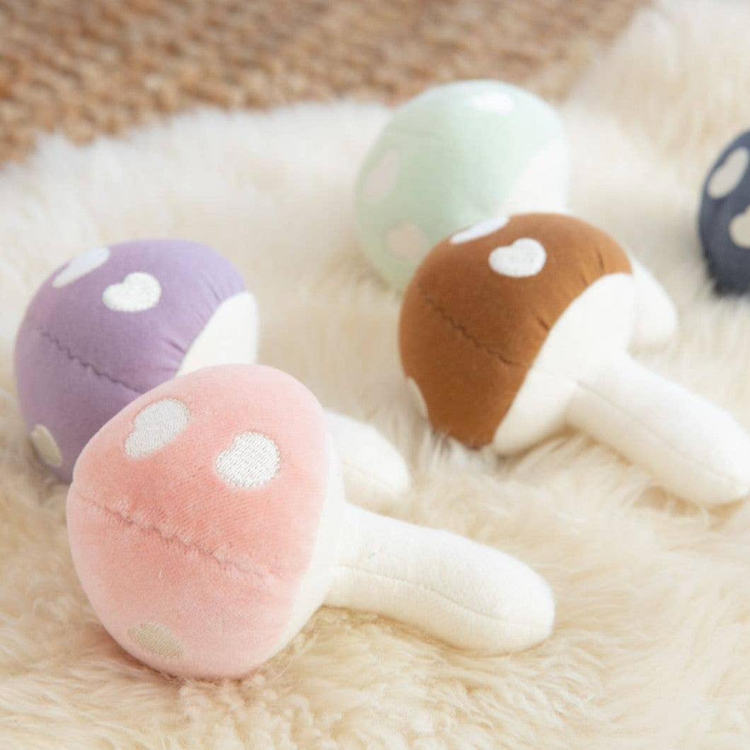 Let this Mushroom Rattle add a touch of whimsy to your baby's toy collection. Made of soft pink velour, it's perfect for tiny hands to shake and play with. It also makes a gentle rattling sound to stimulate sensory development. It's the perfect blend of cute and practical. Fungi never looked so fun! * 100% GOTS certified organic cotton * Filled with organic cotton and naturally hypoallergenic corn fiber * Securely sewn plastic-free, BPA-free, phthalate-free rattle * 5x4 inches