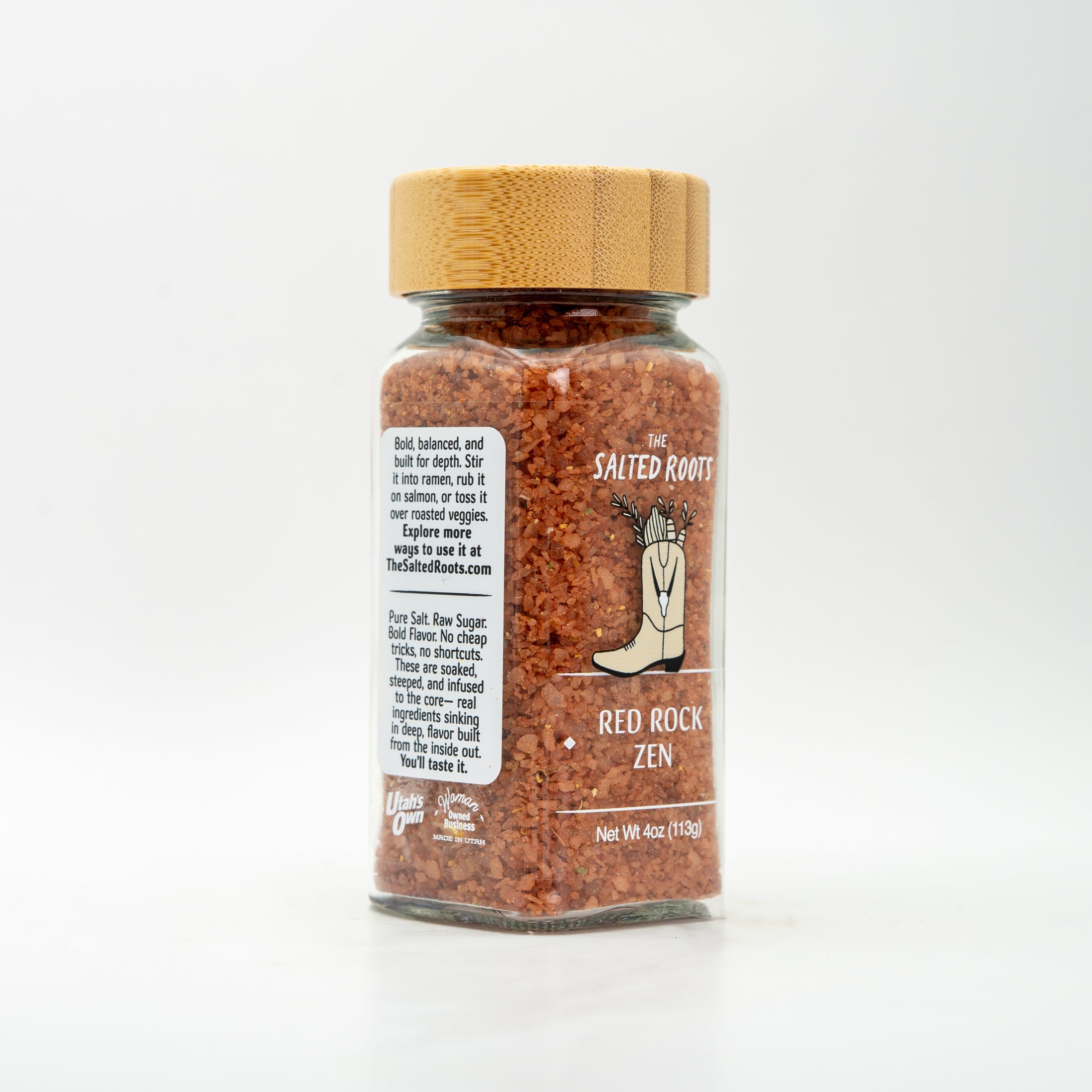 Glass salt jar with wooden lid and labels.