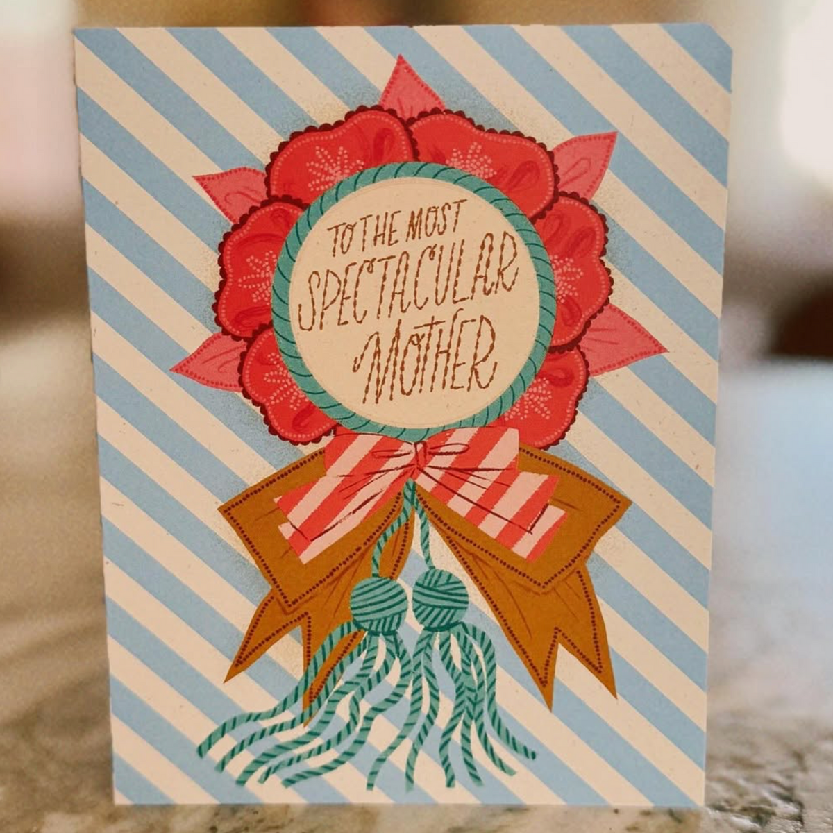 Greeting card with floral design and text on a striped background