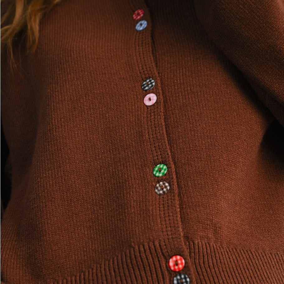 Brown knit long-sleeved cardigan with colorful gingham functioning buttons along front.