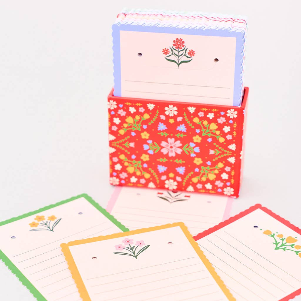 Set of colorful stationery items with floral designs on a white background