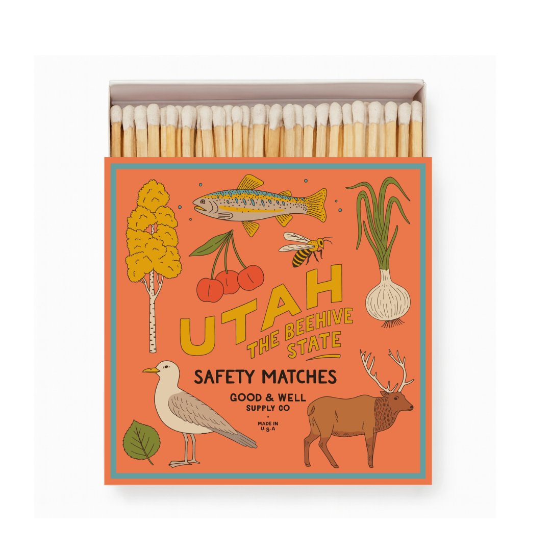 Matches in a box with Utah-themed illustrations on an orange background