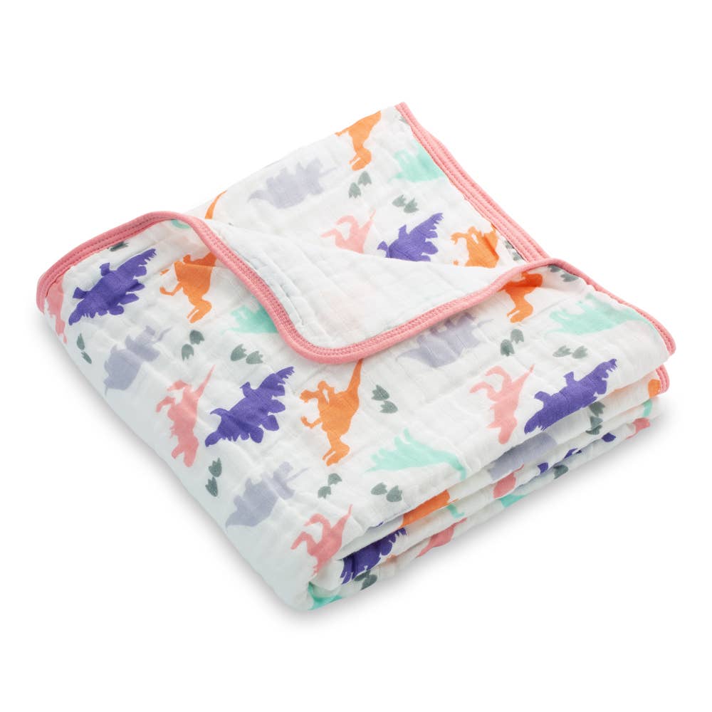 Folded baby blanket with colorful dinosaur pattern on a white background