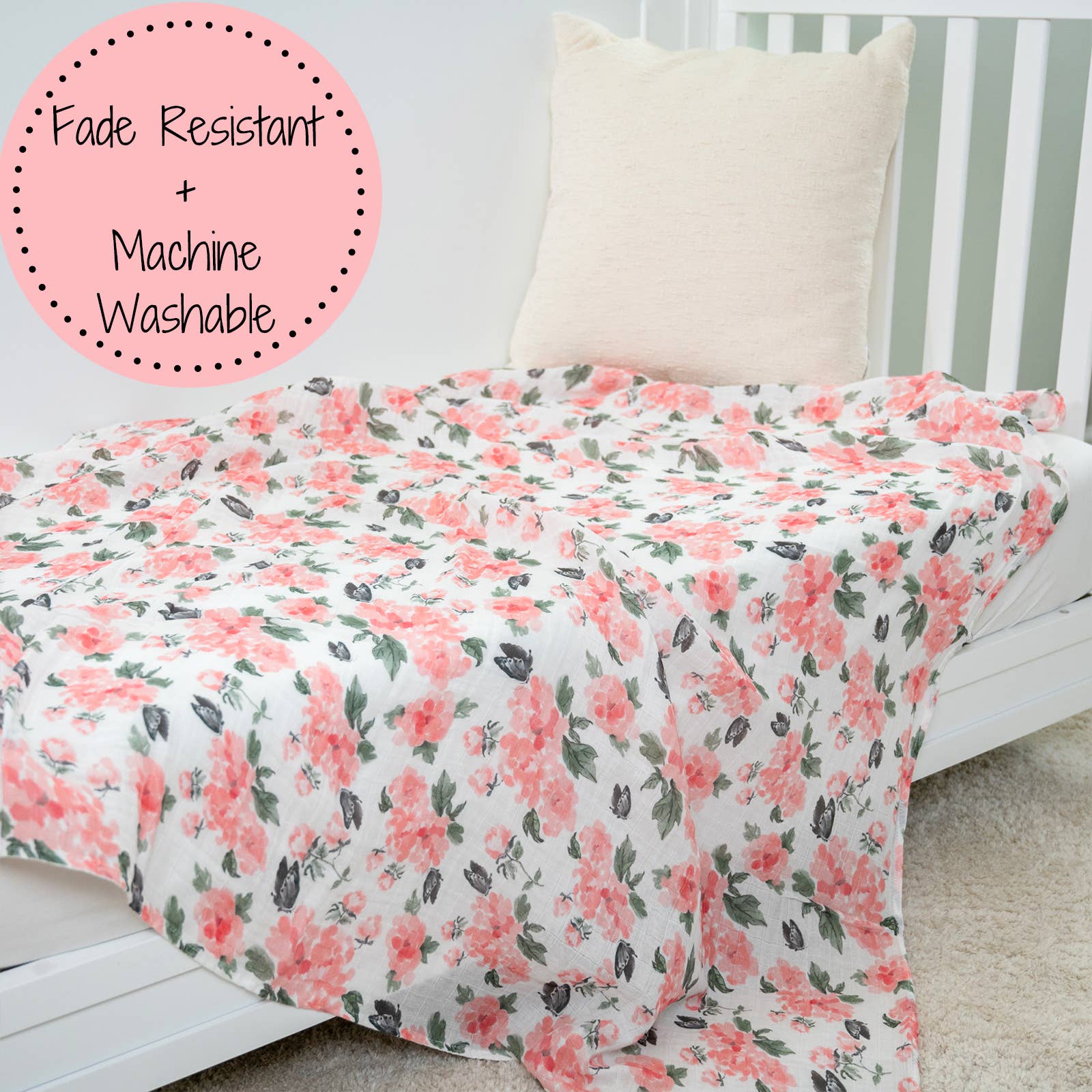 Floral blanket on a bed with a label indicating 'Fade Resistant + Machine Washable'.