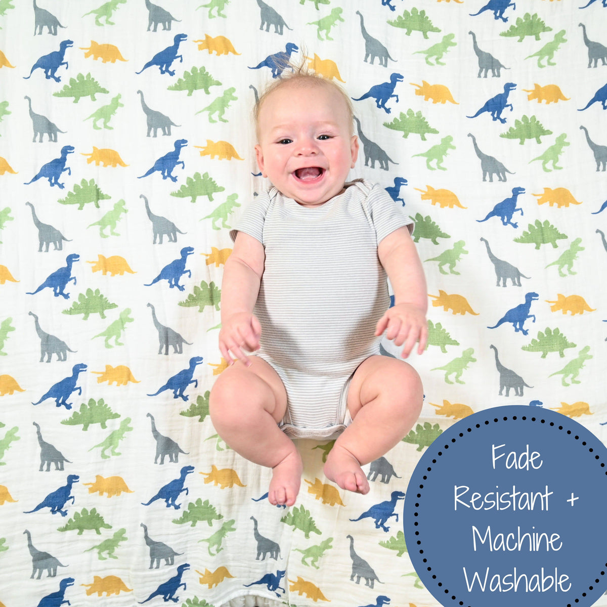 Baby sitting on a sheet with dinosaur pattern, with 'Fade Resistant + Machine Washable' text.