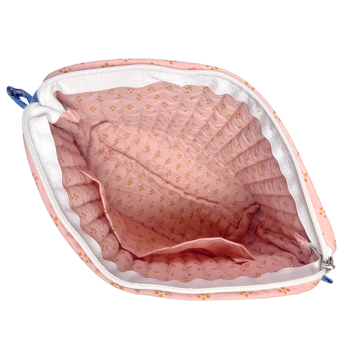 Pink fabric with floral pattern inside a white pouch on a white background