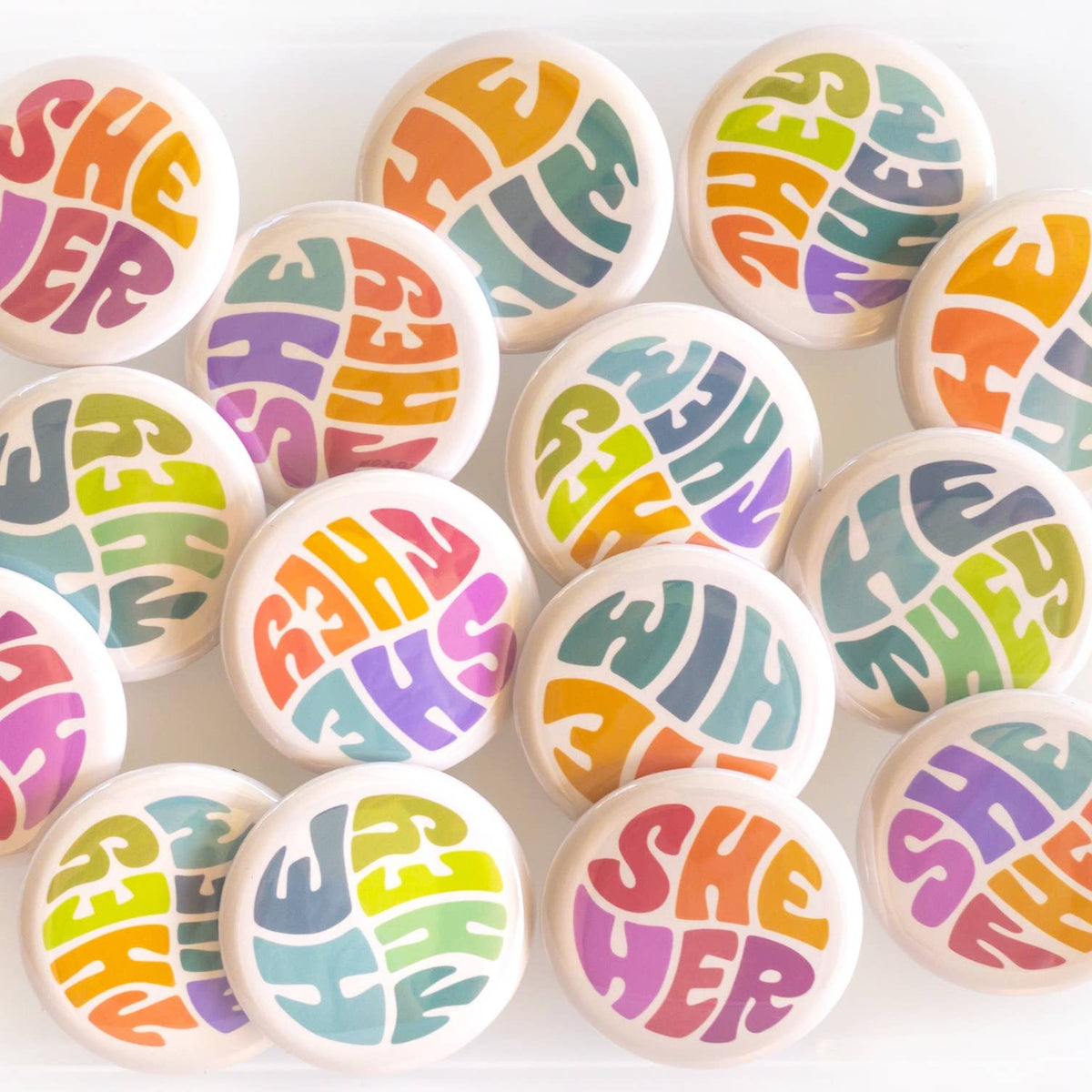Wear your pronouns with pride with these cute retro-style buttons! This pinback button displays "He/They" pronouns in a green and blue color palette. It is the perfect way to let others know how to address you and to show your support for the LGBTQ+ community! Size: 1.25" pinback button