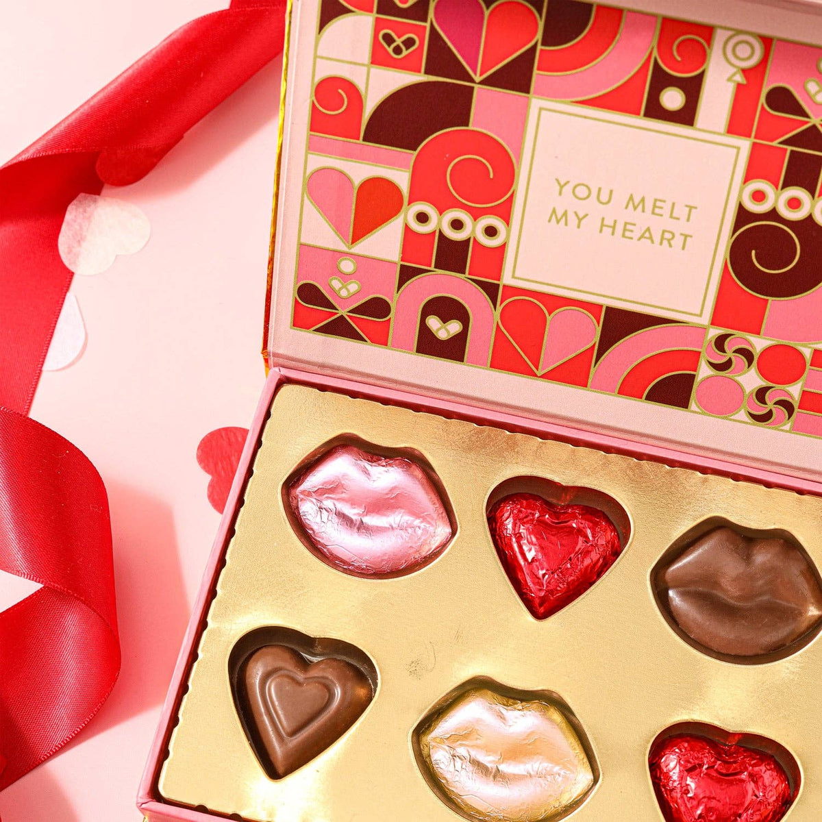 Delight your special someone with our "Love Letter.” This charming pink cardboard box, shaped like an envelope, opens to reveal a delectable assortment of chocolates molded into hearts and lips. Each sweet treat is crafted with love, and the box carries a heartfelt message that reads "You Melt My Heart." Surprise your loved one with this delightful combination of romance and chocolate, making it a truly memorable and delicious gesture.