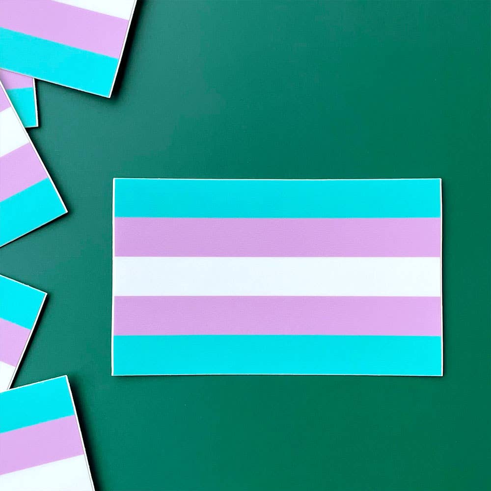 Trans pride flag sticker ready for sticking on laptops, water bottles, your car, or anywhere else you can think of.
The Transgender Pride Flag, created by American Trans woman Monica Helms in 1999, just in sticker form! 3.3" x 2"
