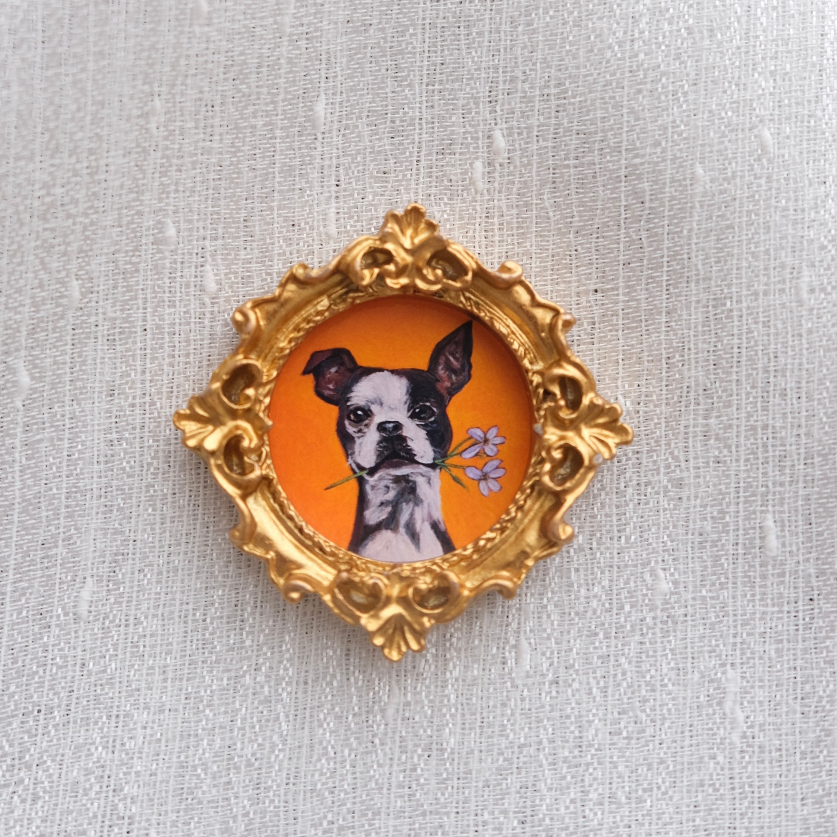 A mini framed art magnet of a sweet Boston terrier with a flower, made to add a little charm to your space.