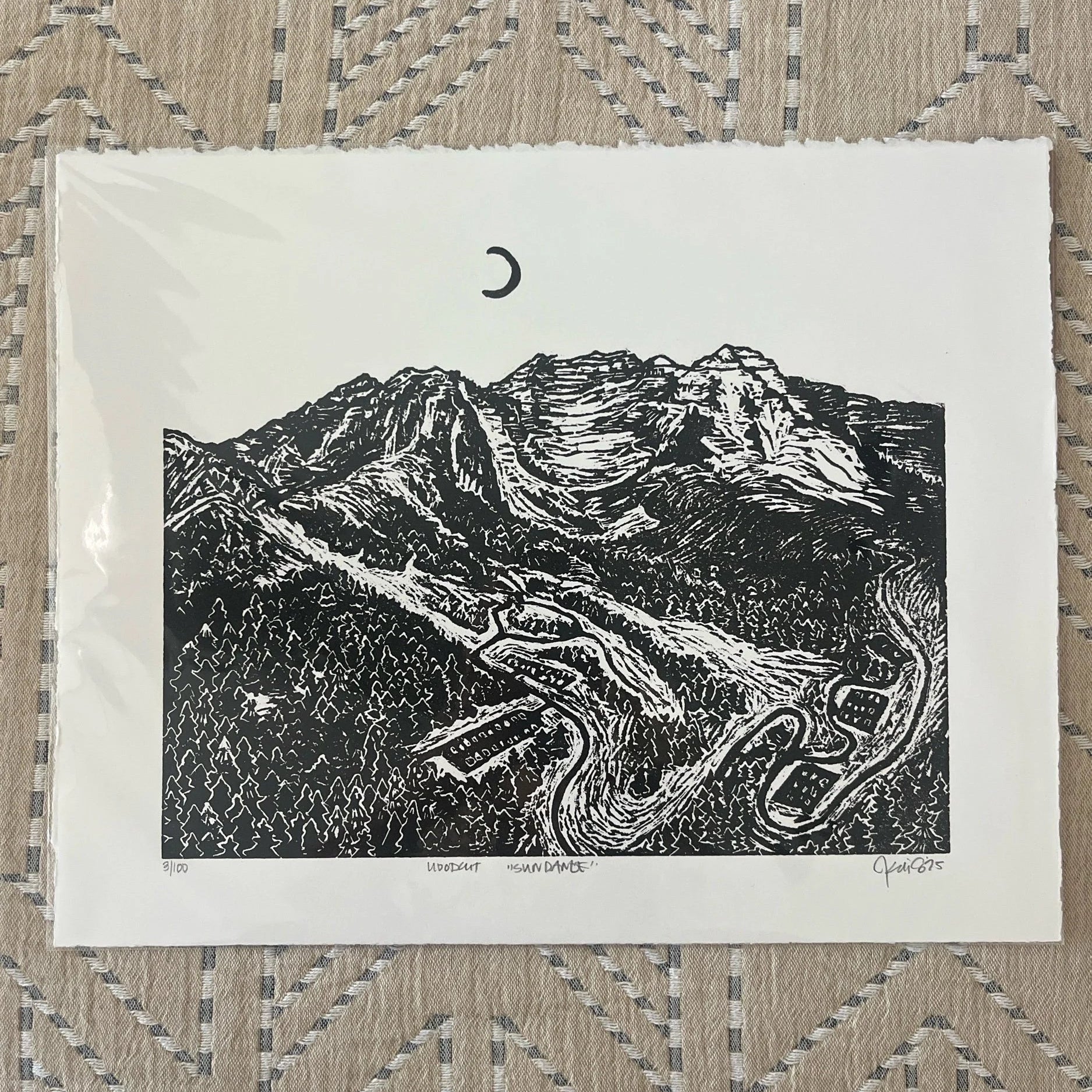 a black and white relief linocut of the sundance canyon with the moon above the canyon