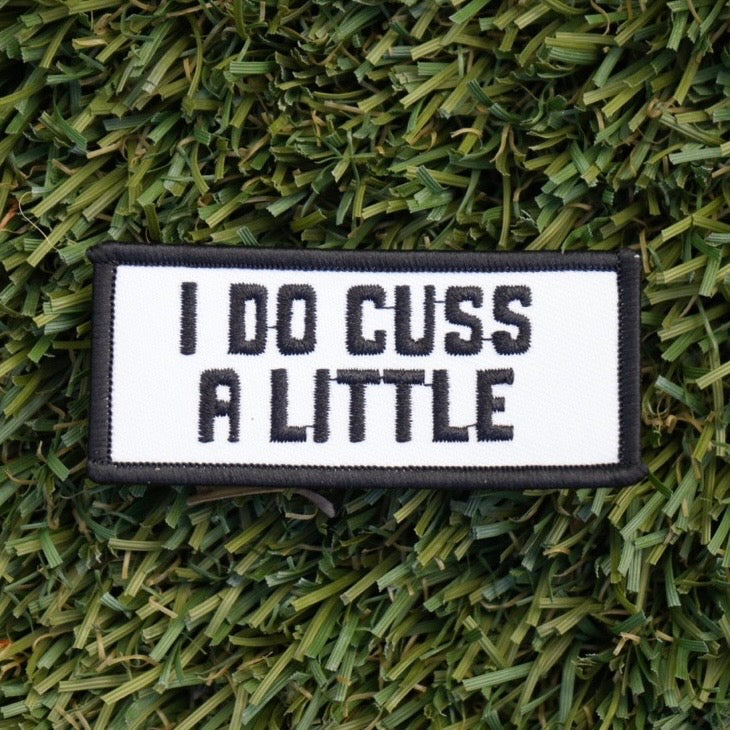 Iron-on rectangular shaped patch with a black border and white background, and words in black that say "I do cuss a little".