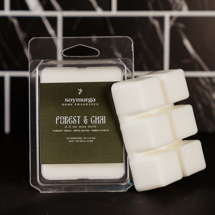 Clear packaging with a moss green label. Pictured against a black marble back splash.