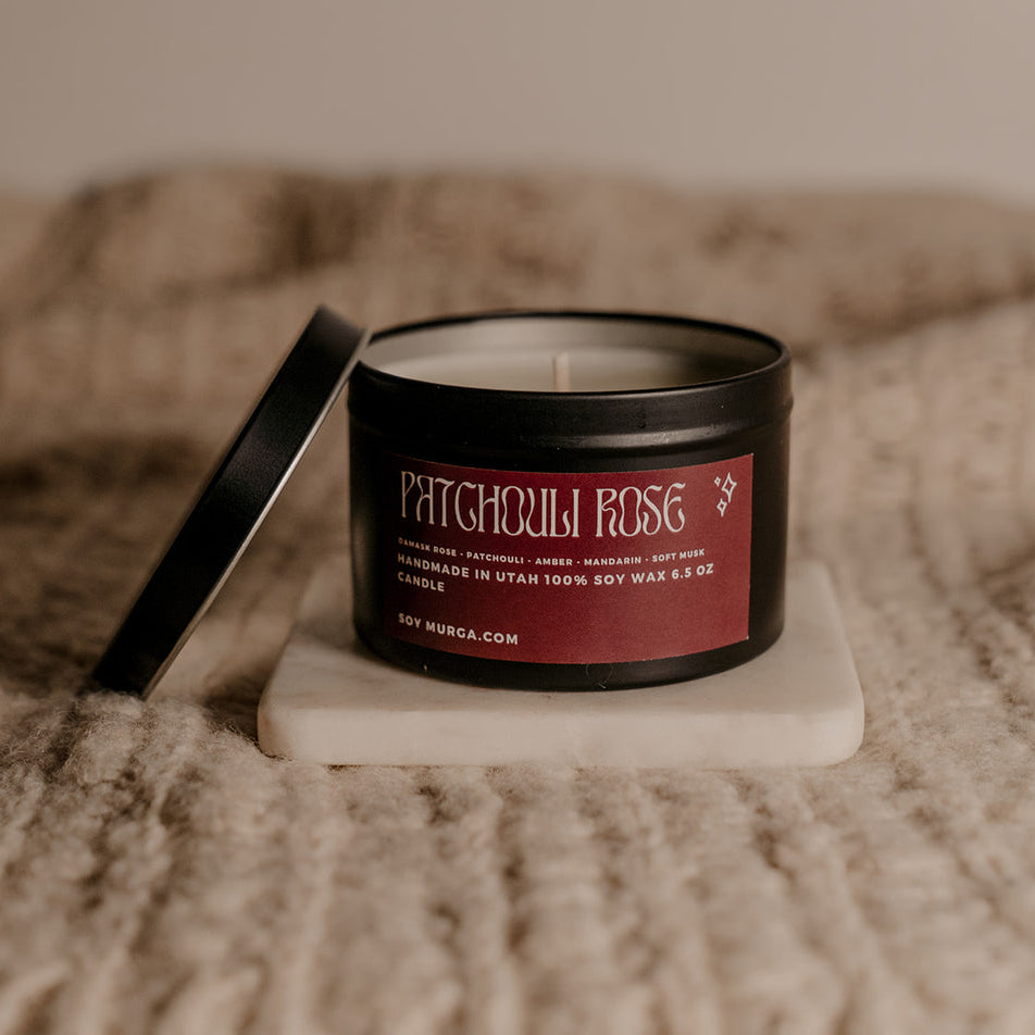 6.5 oz Patchouli Rose candle in matte black tin.