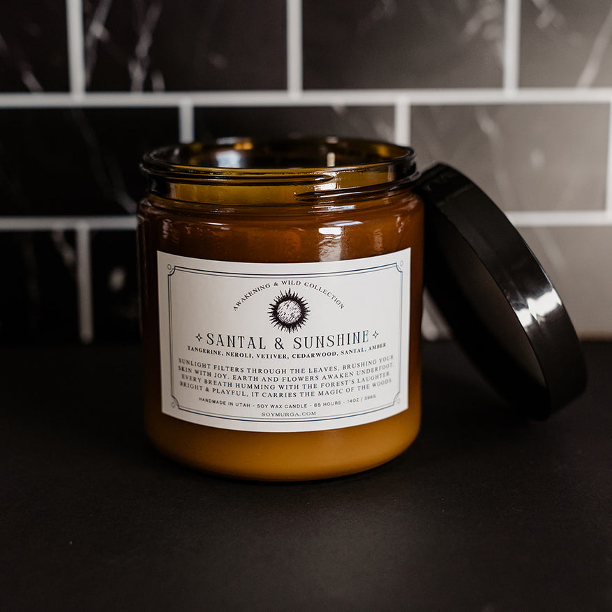 14 oz Santal & Sunshine candle in an amber glass jar and double wicks.