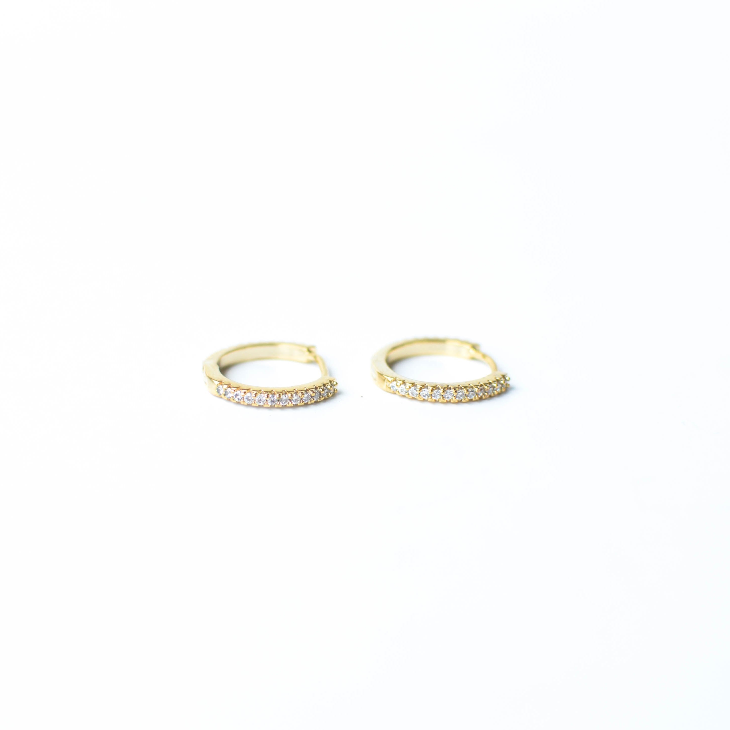 Our gold diamond huggies have been our bestselling earring for over a year, and it's no wonder. With a stunning and classic design, these earrings go with EV. ERY. THING. They are both timeless and on trend. Their unique click in click out clasp allows you to leave them in day and night without any discomfort. 