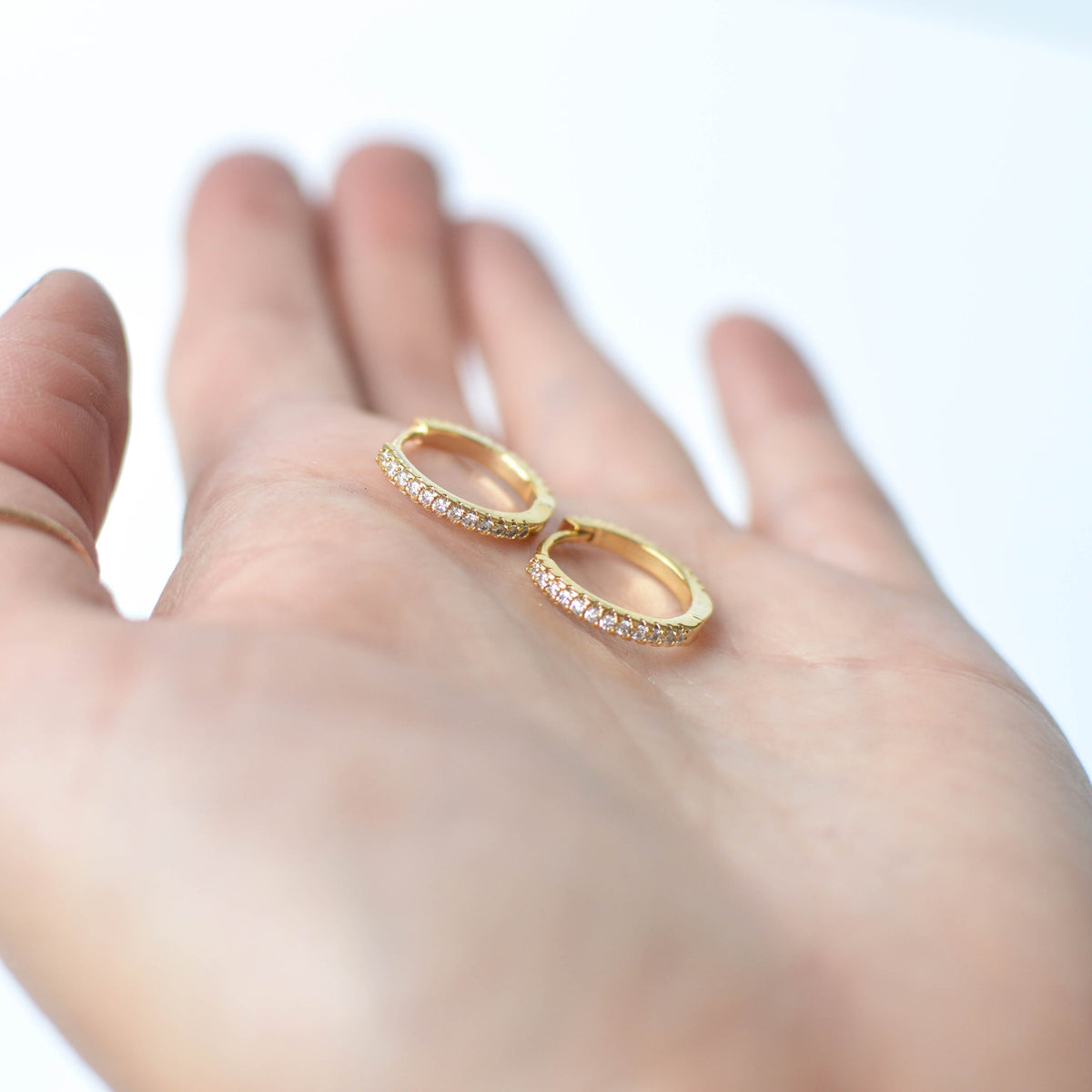 Our gold diamond huggies have been our bestselling earring for over a year, and it's no wonder. With a stunning and classic design, these earrings go with EV. ERY. THING. They are both timeless and on trend. Their unique click in click out clasp allows you to leave them in day and night without any discomfort. 
