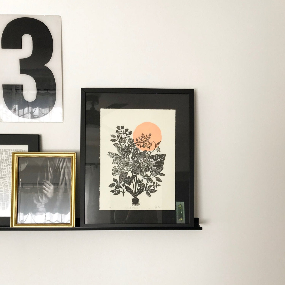 hand carved and pressed black and white 11x14 floral print with a pink circle in a black frame