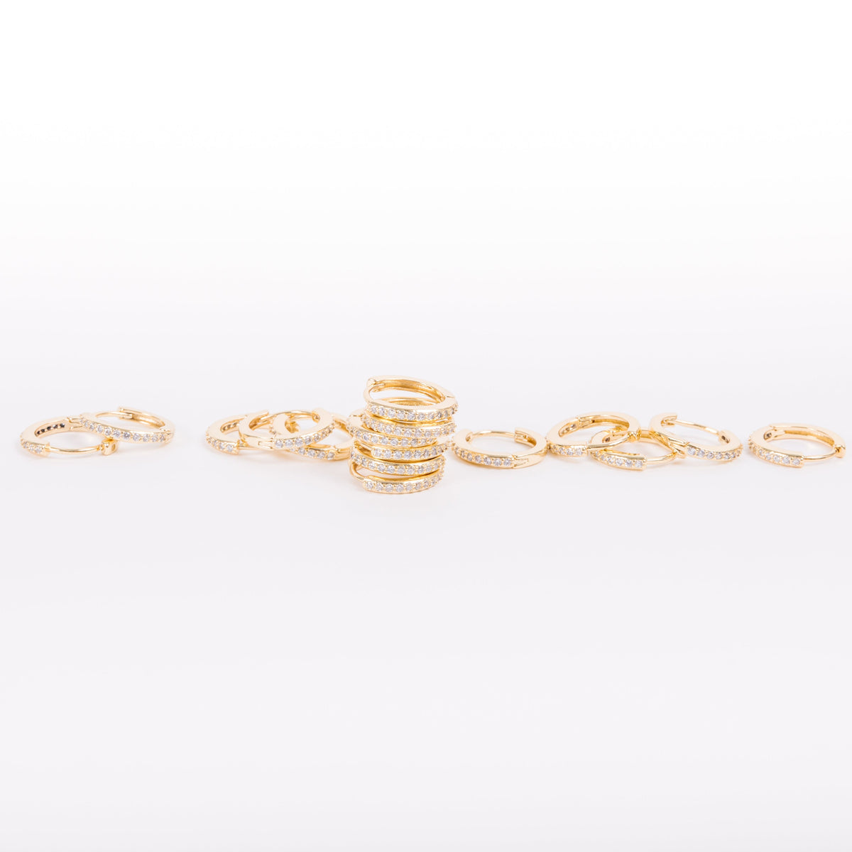 Our gold diamond huggies have been our bestselling earring for over a year, and it's no wonder. With a stunning and classic design, these earrings go with EV. ERY. THING. They are both timeless and on trend. Their unique click in click out clasp allows you to leave them in day and night without any discomfort. 