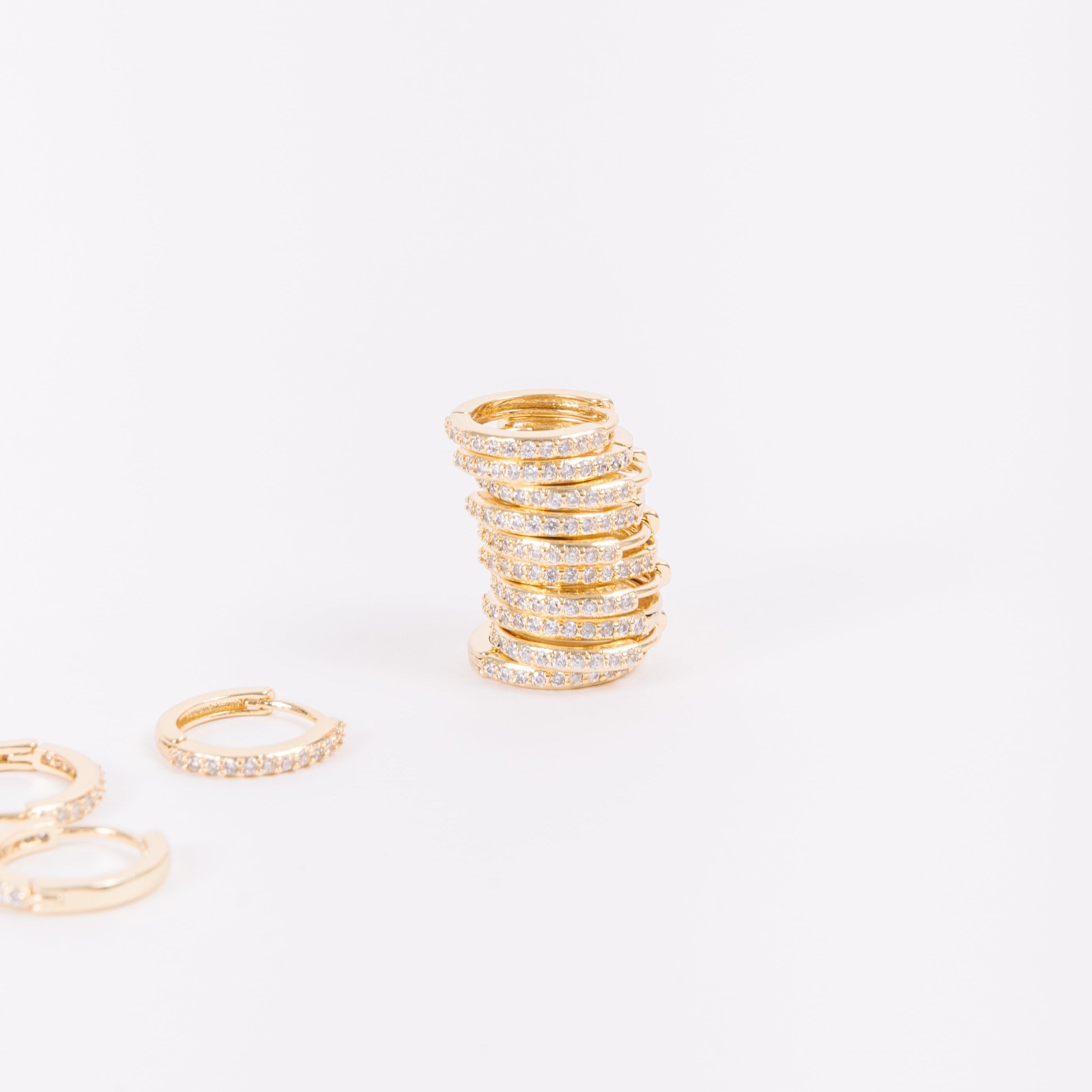 Our gold diamond huggies have been our bestselling earring for over a year, and it's no wonder. With a stunning and classic design, these earrings go with EV. ERY. THING. They are both timeless and on trend. Their unique click in click out clasp allows you to leave them in day and night without any discomfort. 