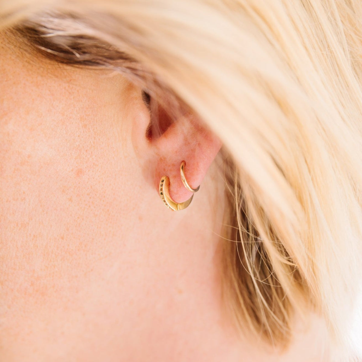 14k Gold Filled 12 mm huggie clasp Safe for sensitive skin Unique clasp has no post when earrings are closed, allowing for comfortable wear and sleep without having to remove earrings Multicolored bejeweld stones are 2 mm Perfect for mulitple piercings Freaking cute and freaking tiny