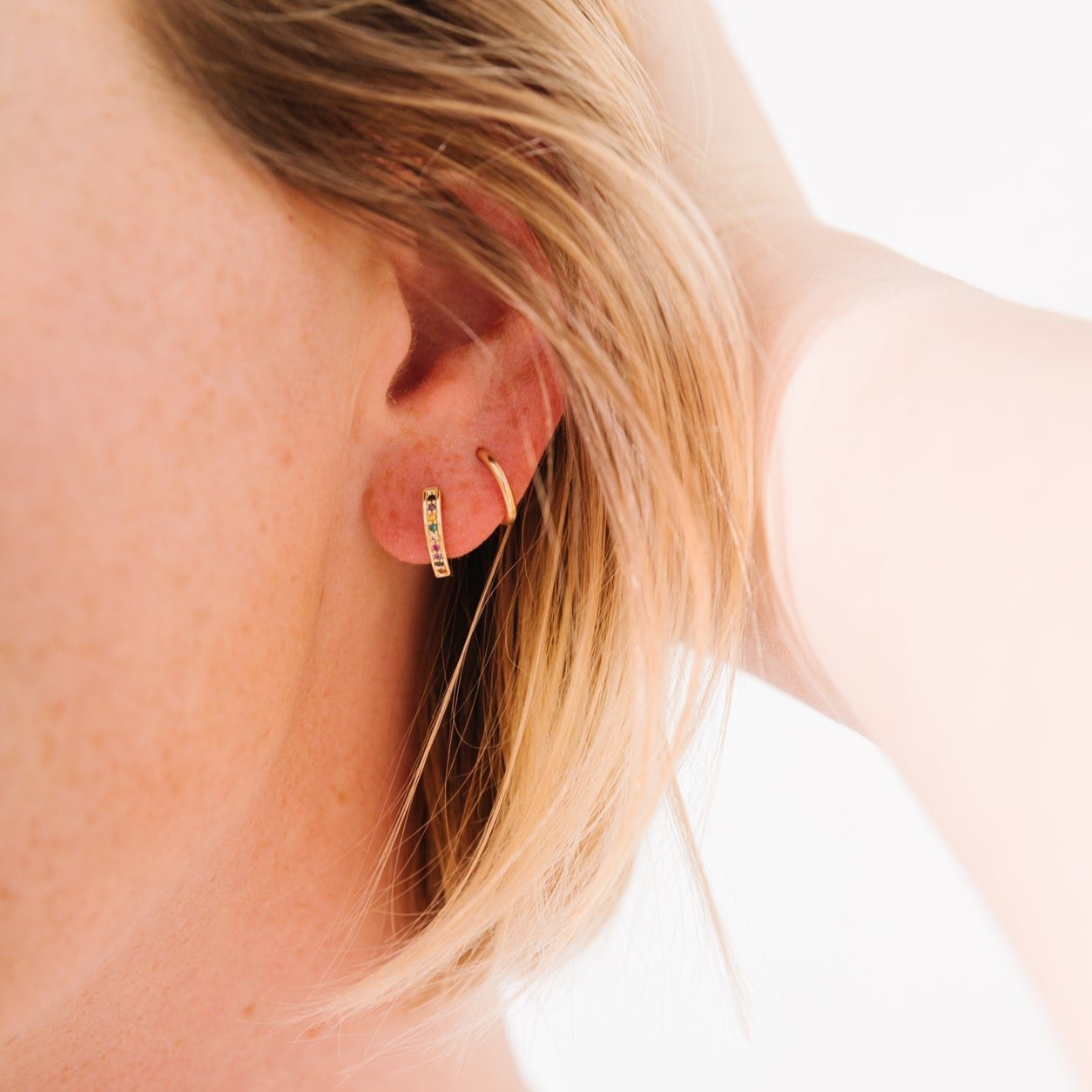 14k Gold Filled 12 mm huggie clasp Safe for sensitive skin Unique clasp has no post when earrings are closed, allowing for comfortable wear and sleep without having to remove earrings Multicolored bejeweld stones are 2 mm Perfect for mulitple piercings Freaking cute and freaking tiny