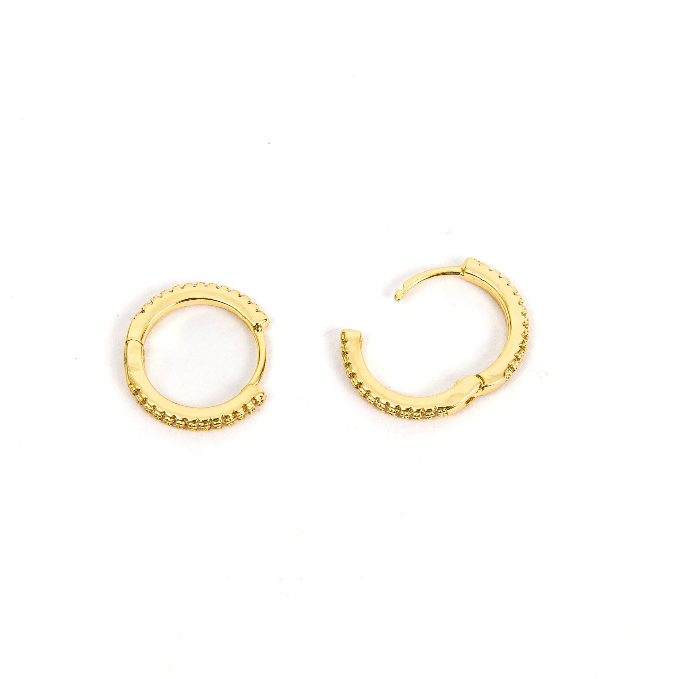 Gold huggies with inset diamonds.