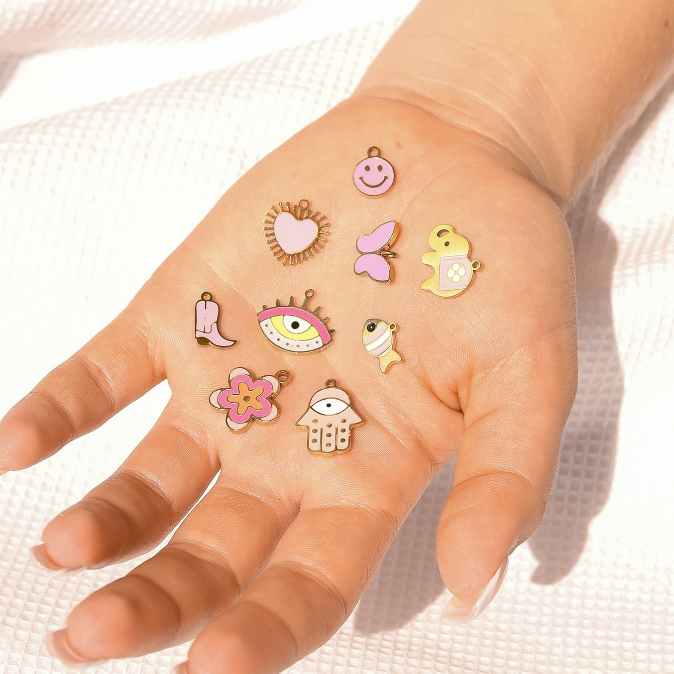 Give your jewelry collection an eye-catching update with our 18K Gold PVD Eye Charm. The playful pink details add a pop of color to this unique charm featuring an eye design. Perfect for adding some whimsy to any accessory, this charm is sure to turn heads!