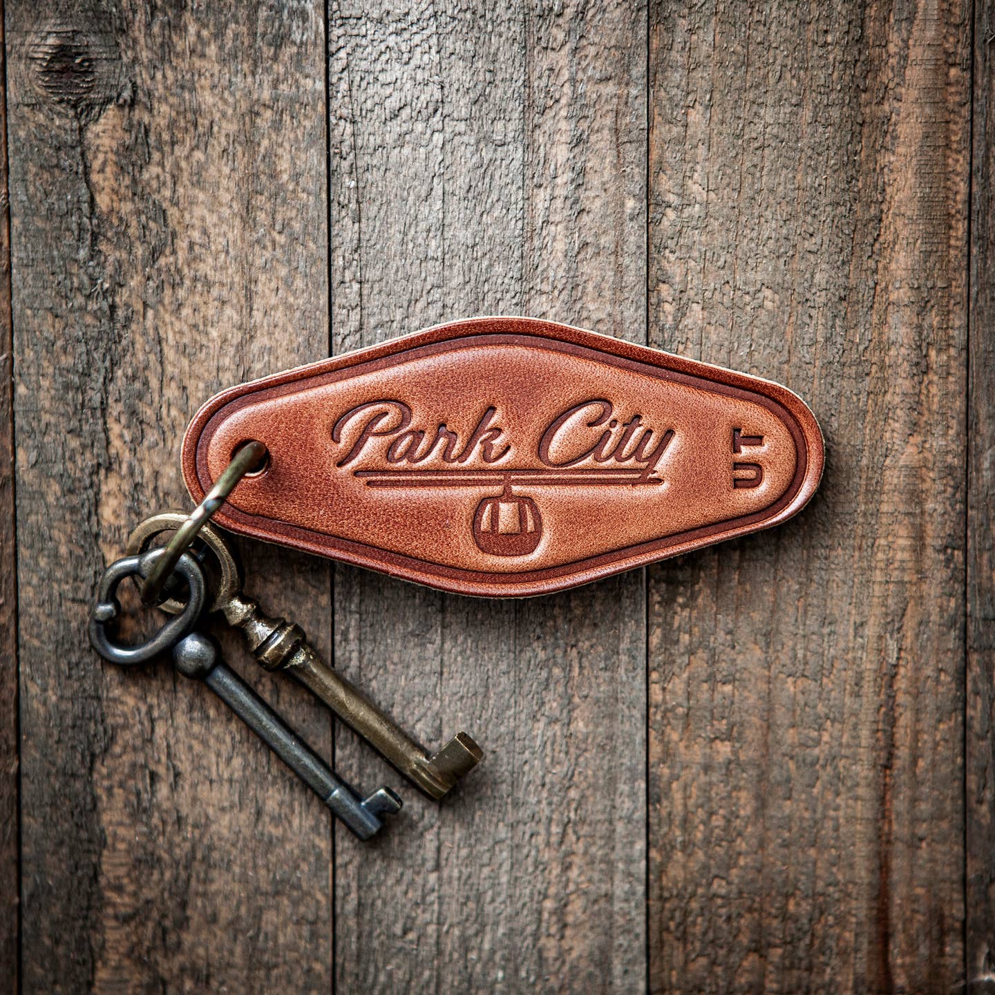 This leather keychain comes in a classic motel style with “Park City” beautifully written in calligraphy on the front. Our leather keychains are cut and pressed by hand from some of the thickest and finest harness leather available, and patina beautifully as they age.
Size: 4”