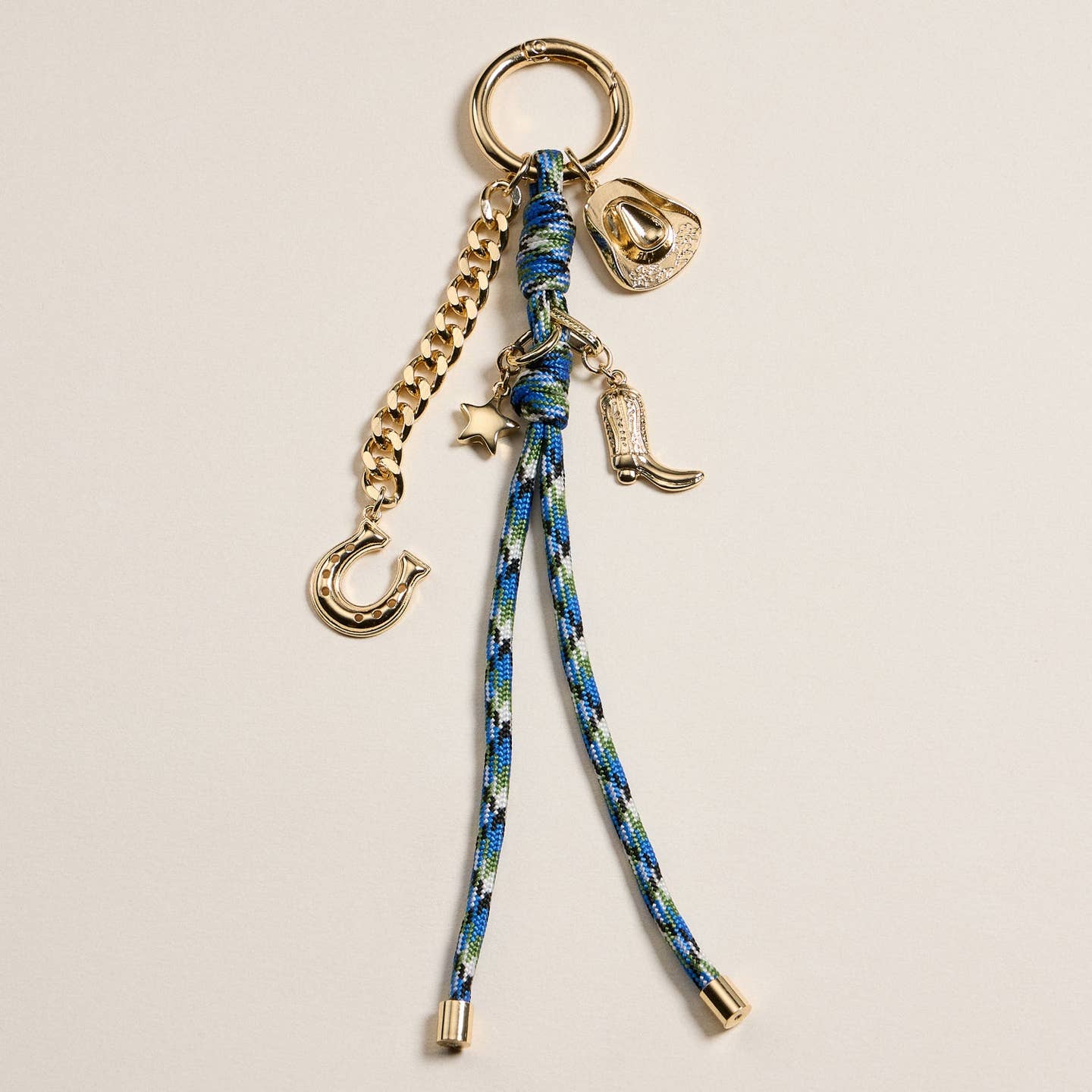 Add a touch of western flair to your accessories with this 7.5 inch Western Charm Keychain. Crafted from durable enamel with gold-tone accents, it features playful charms including a cowboy hat, boot, horseshoe, and star. The multicolor braided rope adds a rustic vibe while the gold chain enhances its modern style. Perfect for keys, bags, or as a unique gift.
Details:
Materials:Enamel and gold-tone alloy
Charms:Cowboy hat, boot, horseshoe, star
Length: 7.5 inches
Use: Keychain, bag charm, purse accessory