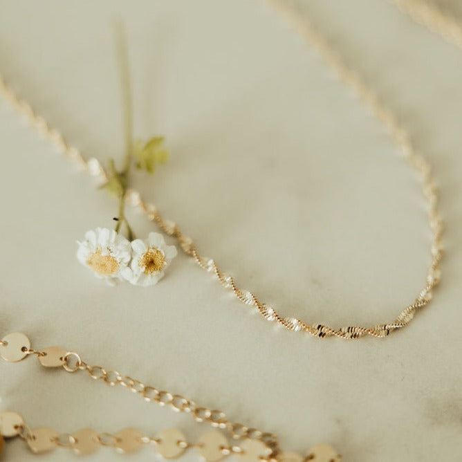 The Amelia Gold Filled Twist Necklace is the perfect piece to stack with other necklaces or wear as a stand alone accessory. She’s 18k gold filled, tarnish and wear resistant, and made to last. Hypoallergenic and nickel free, this unique and dainty 3mm chain is the perfect accessory all year long. 16" length.
