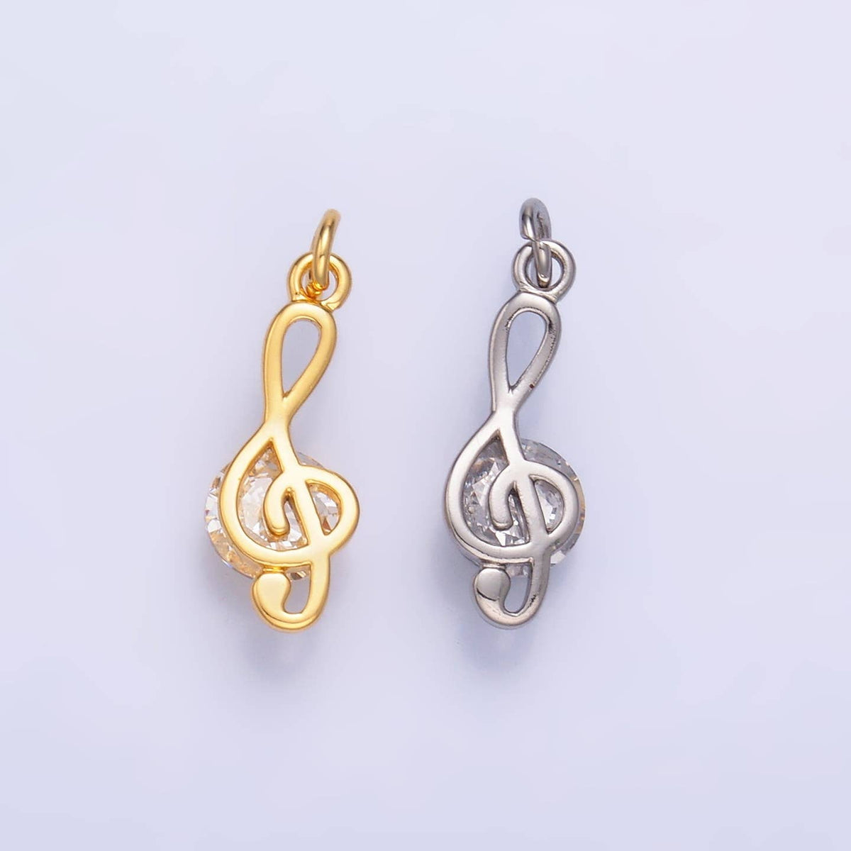 Elegant treble clef charm crafted from brass and gold-filled metal, adorned with sparkling cubic zirconia accents. Available in warm gold or cool silver finishes to match your style. This delicate musical note pendant measures 16.4mm x 6mm x 5.1mm, making it the perfect size for charm bracelets and necklaces. Hypoallergenic construction—lead-free and nickel-free for sensitive skin. A beautiful addition for music lovers and charm collectors alike.