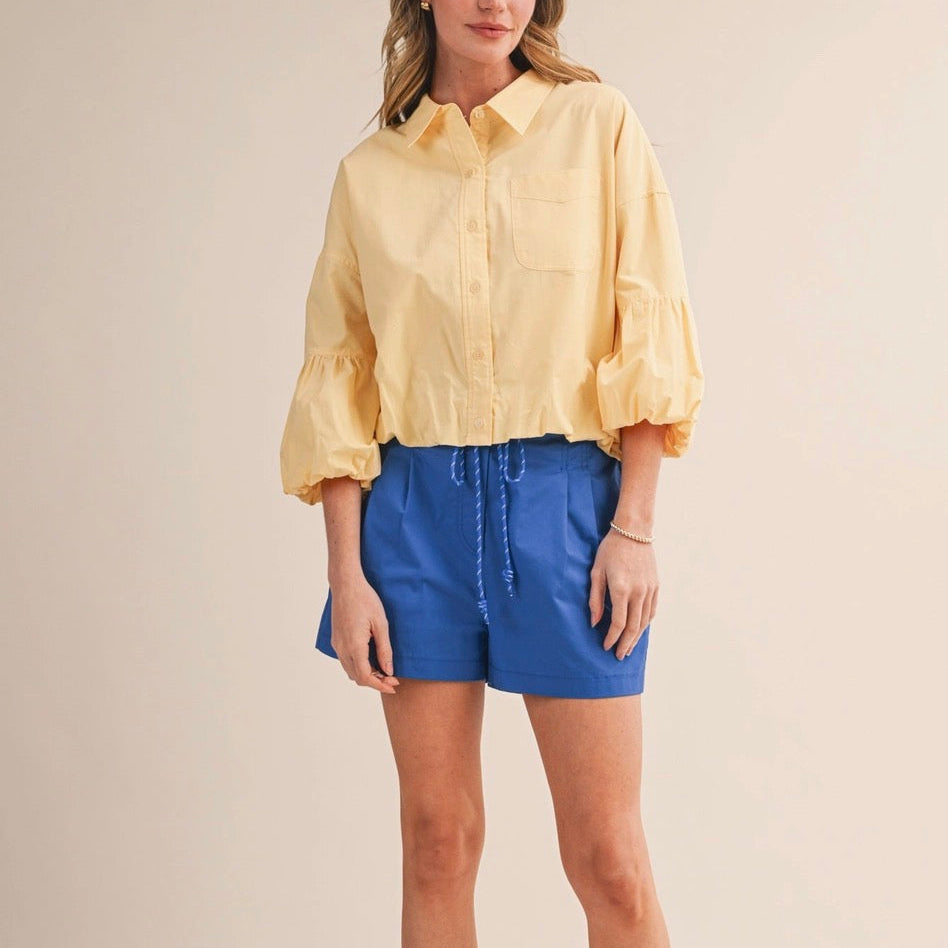 Embrace effortless summer style with these Ocean Blue Rope Trim Belt Pleated Shorts. Crafted from 100% cotton, they feature a flattering high-rise pleated waist and a charming rope-trimmed belt with seam detail—perfect for adding personality to your everyday look. The structured silhouette includes functional side seam pockets and back faux welt pockets, while the lined interior keeps you comfortable all day long. Zip and button closure with belt loops complete this versatile piece.