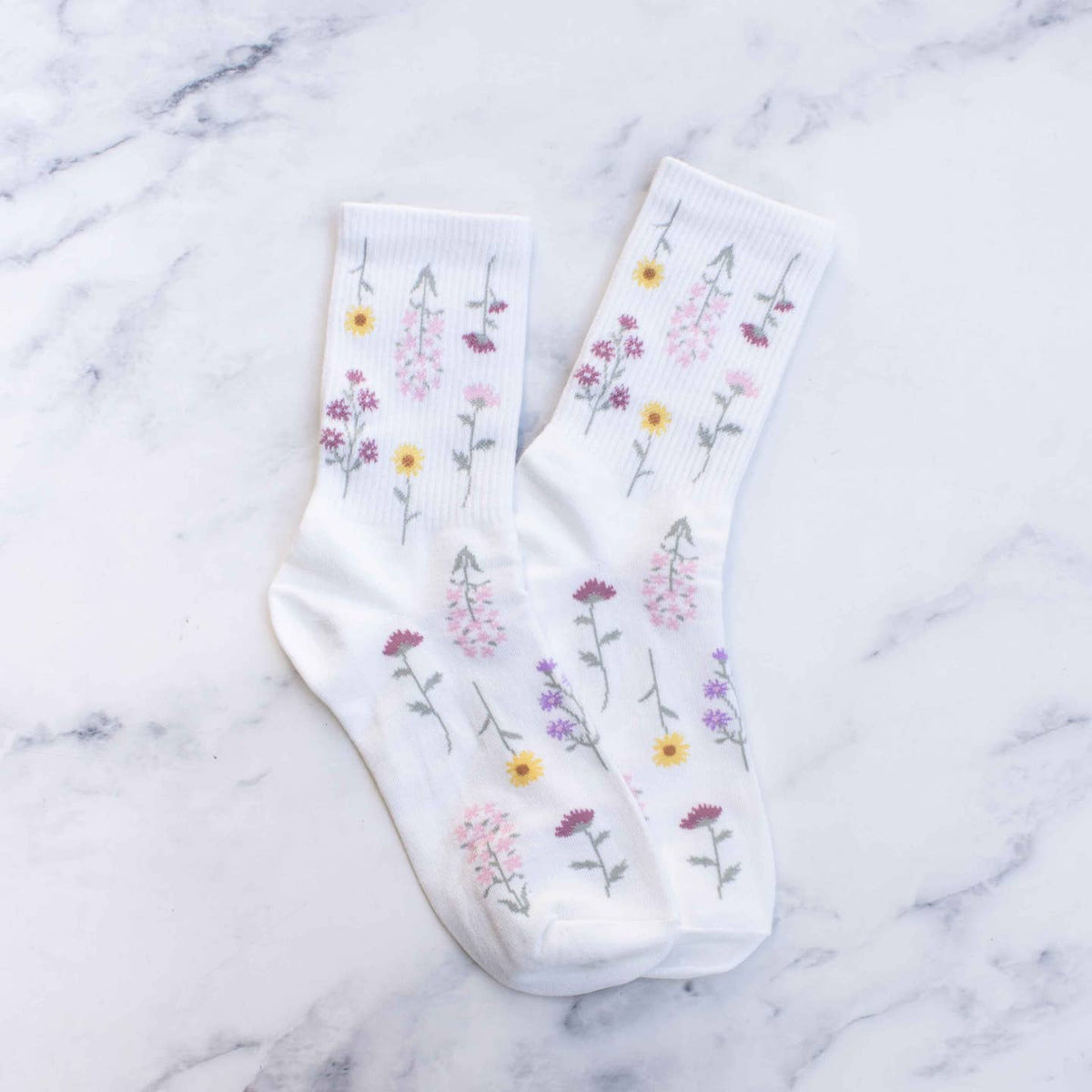 Add a touch of whimsy to your outfit with these playful sage floral socks! Featuring a charming botanical pattern, these socks are made to make a statement. Get ready to turn heads and show off your fun side with these quirky socks.
