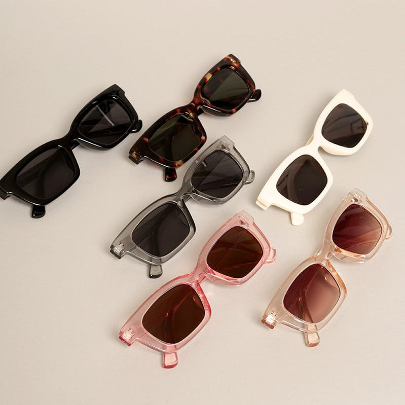Classic rectangular sunglasses designed for everyday wear. These women's frames feature a timeless silhouette available in 7 versatile colors including white, black, and tortoise—perfect for any wardrobe. Each pair includes polycarbonate lenses with UV400 protection against UVA and UVB rays, plus impact-resistant construction for durability. Measuring 5.5" x 1.5", they offer a comfortable regular width fit.