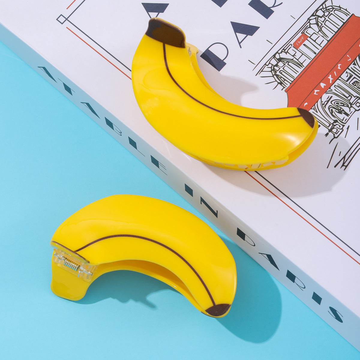 Add a fun and fresh pop of color to your hairstyle with these cute banana-shaped hair clips. Featuring a vibrant yellow finish and realistic fruit detailing, these clips bring a playful, summery vibe to any look.
Equipped with a sturdy spring clasp, they offer a secure and comfortable hold for medium to thick hair, perfect for daily wear or adding a quirky touch to your outfit. Stand out from the crowd with this adorable fruit-inspired accessory!