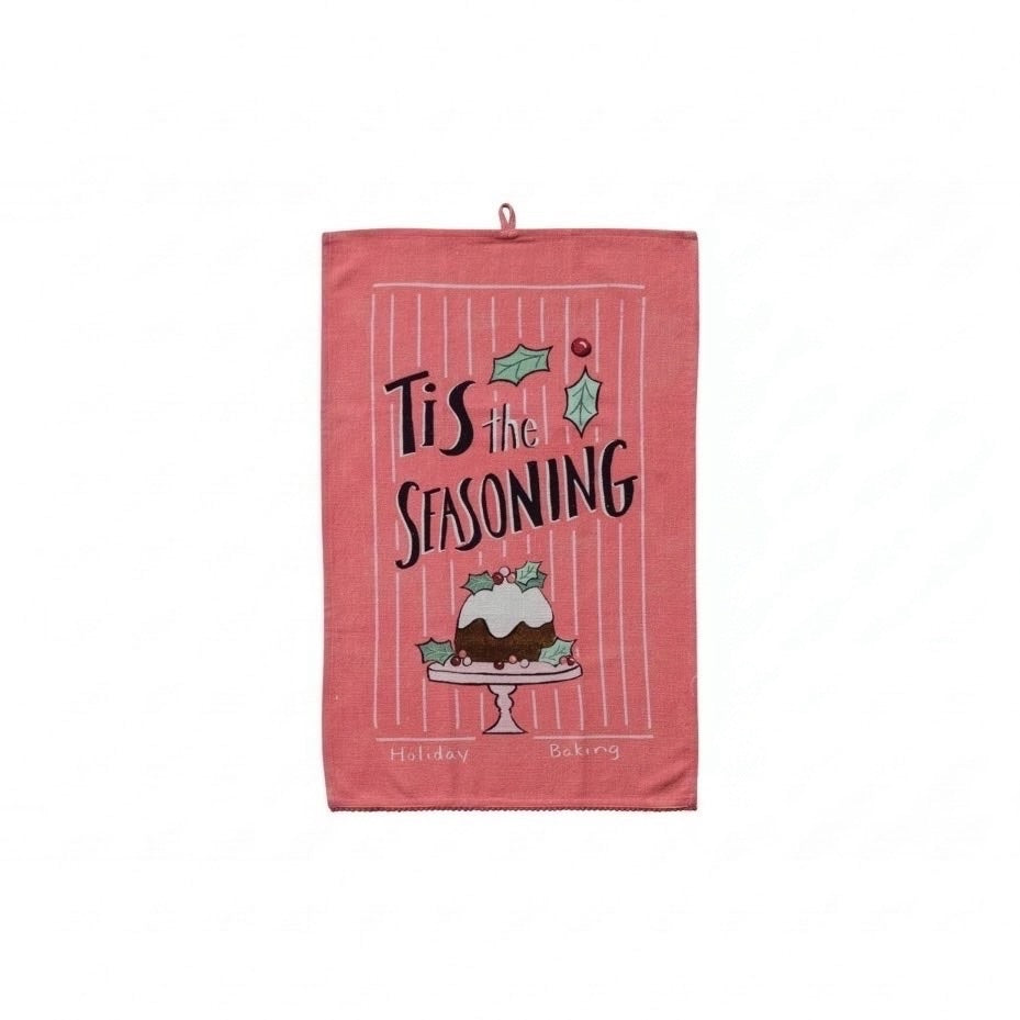 Bring extra warmth and festive cheer into your kitchen with the Soft Holiday Whimsy Tea Towel featuring the delightful phrase "'Tis the Seasoning." Accentuated with playful pom-pom trim and a cheerful holiday image, this charming towel is perfect for adding a touch of cozy joy to your home or gifting to someone special during the holidays.