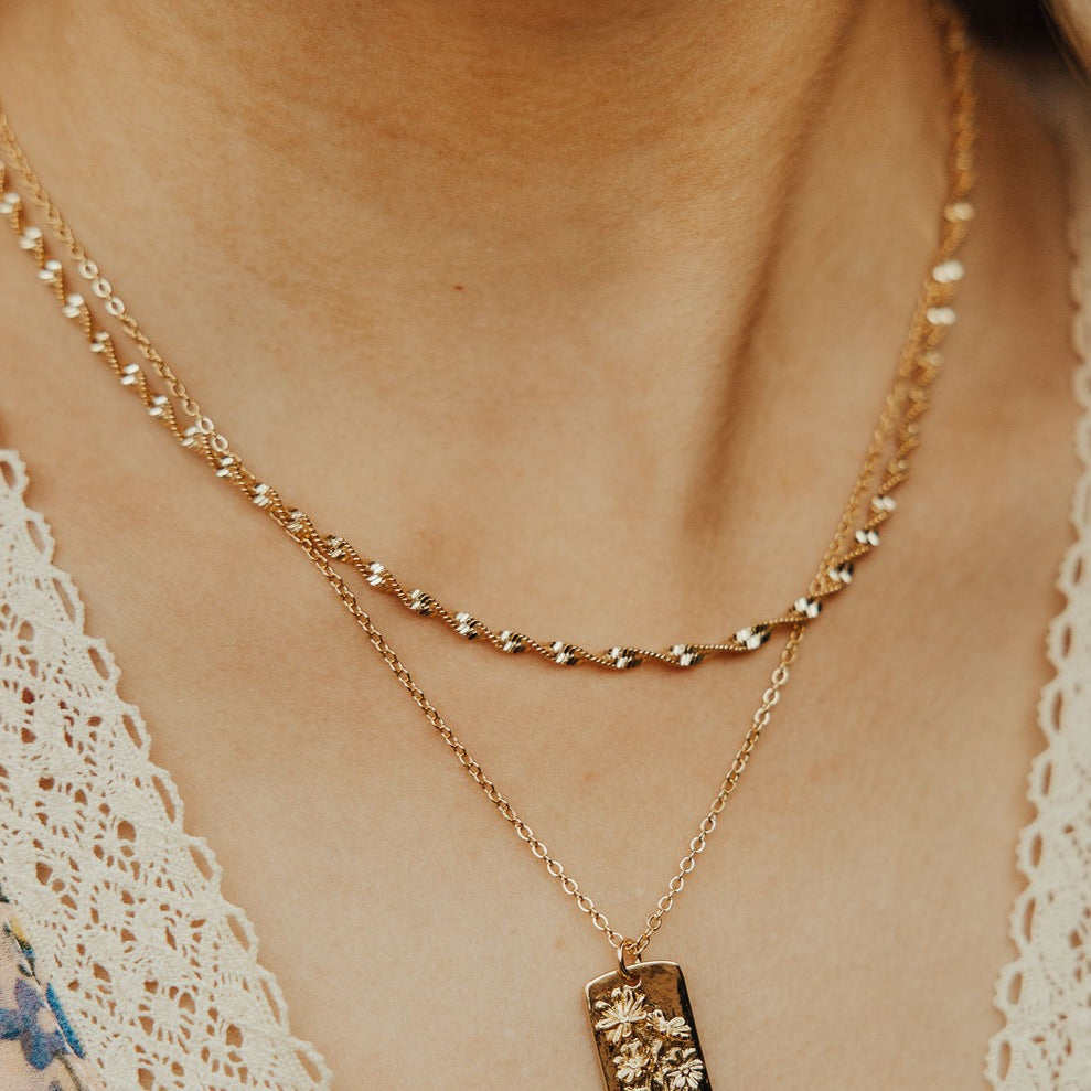 The Amelia Gold Filled Twist Necklace is the perfect piece to stack with other necklaces or wear as a stand alone accessory. She’s 18k gold filled, tarnish and wear resistant, and made to last. Hypoallergenic and nickel free, this unique and dainty 3mm chain is the perfect accessory all year long. 16" length.