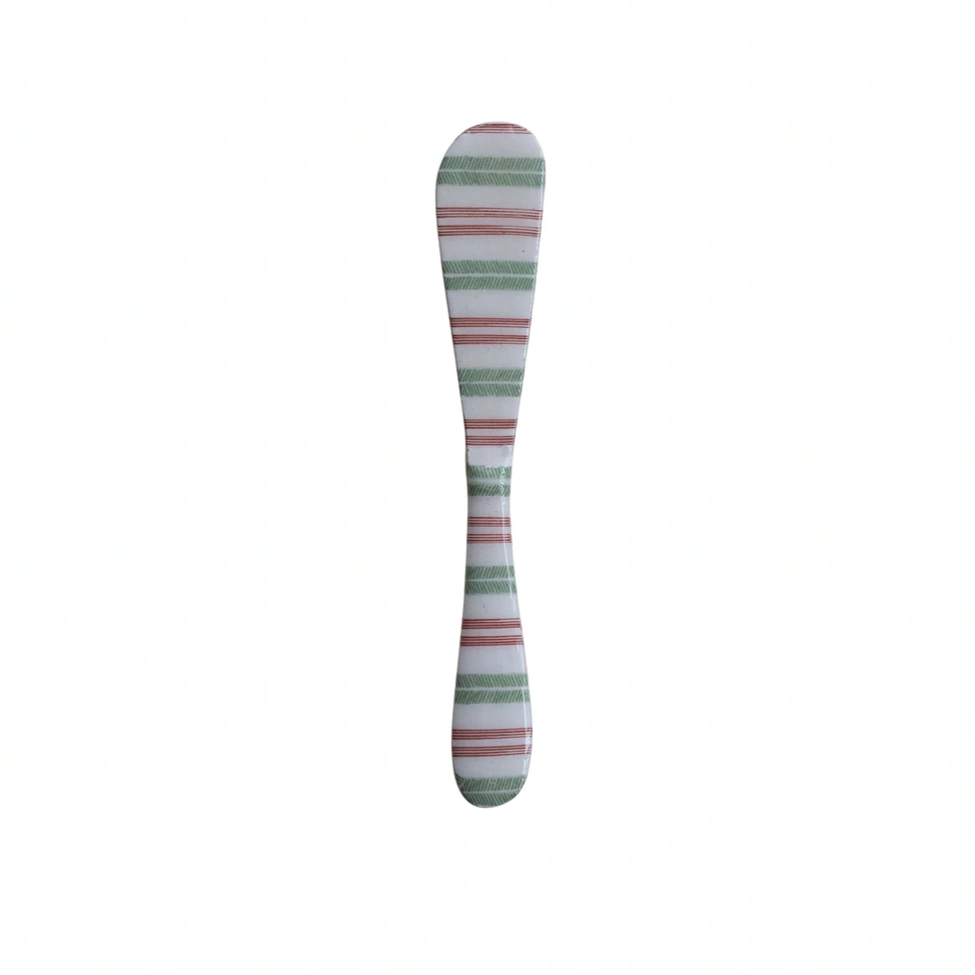 Striped butter knife on a white background