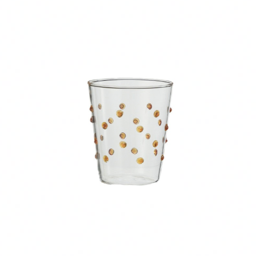 Clear glass with amber polka dots on a white background