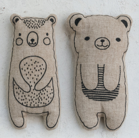 Two bear-shaped plush toys with black outlines on a white background