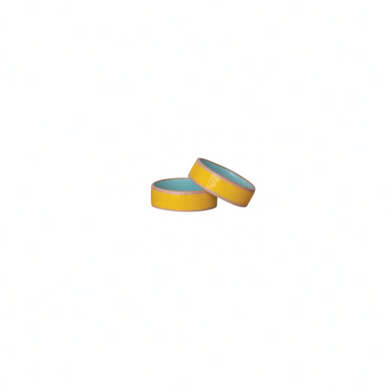 Yellow enameled napkin rings with pink line on each side