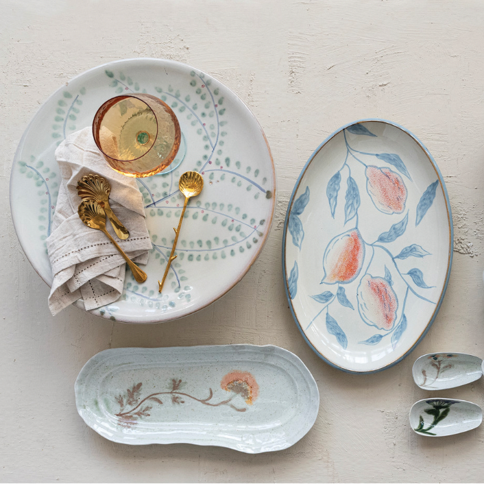 Ceramic plates with floral designs on a light surface