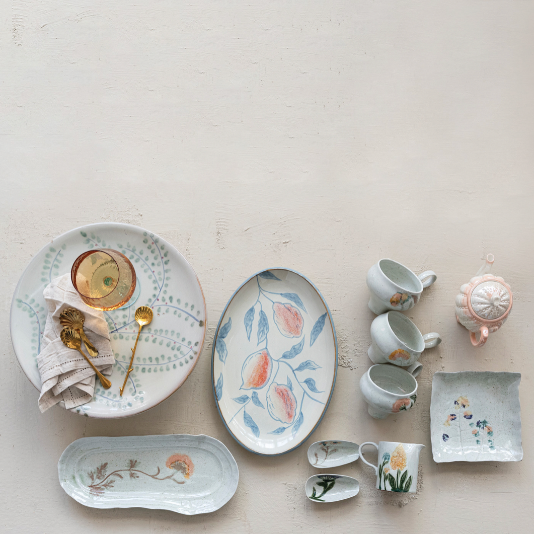 Collection of ceramic dishes with floral patterns on a light background