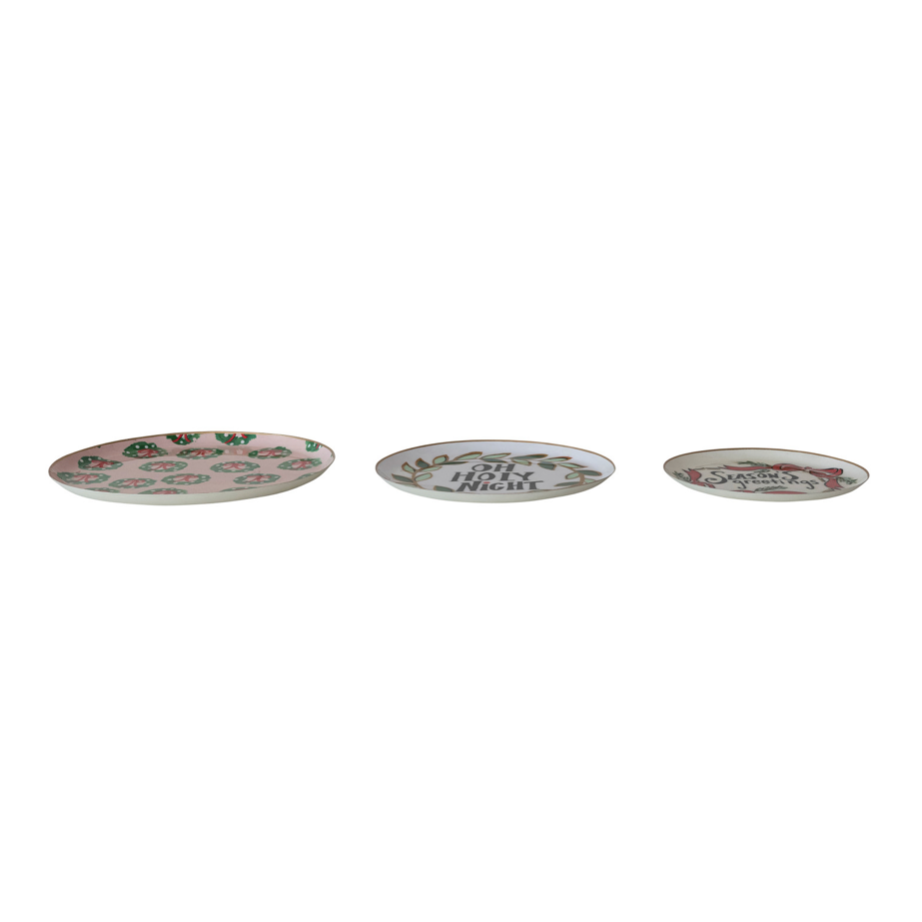 Three oval ceramic plates with pink floral designs and decorative text, arranged horizontally on a plain white background.