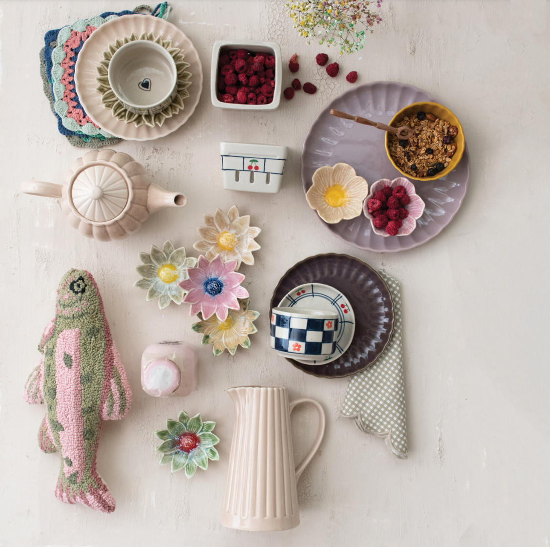 Assorted ceramic dishes and kitchen items on a light surface