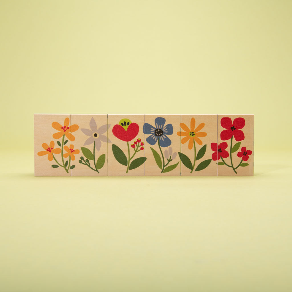 This floral frenzy is busting out with fun! Build your own garden scene. Six blocks feature tulips, colorful flowers, caterpillars, a butterfly, and more. Can you count the petals? How will you measure the inchworm with the ruler? More than colorful educational blocks, this artful set is a decorative puzzle, too. It’s blooming beautiful! 6 - 3 x 1.75 inch blocks
