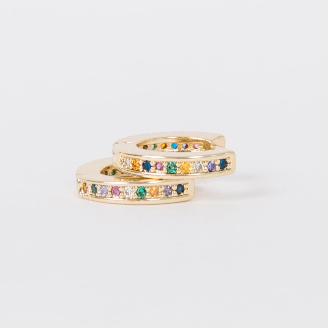 14k Gold Filled 12 mm huggie clasp Safe for sensitive skin Unique clasp has no post when earrings are closed, allowing for comfortable wear and sleep without having to remove earrings Multicolored bejeweld stones are 2 mm Perfect for mulitple piercings Freaking cute and freaking tiny