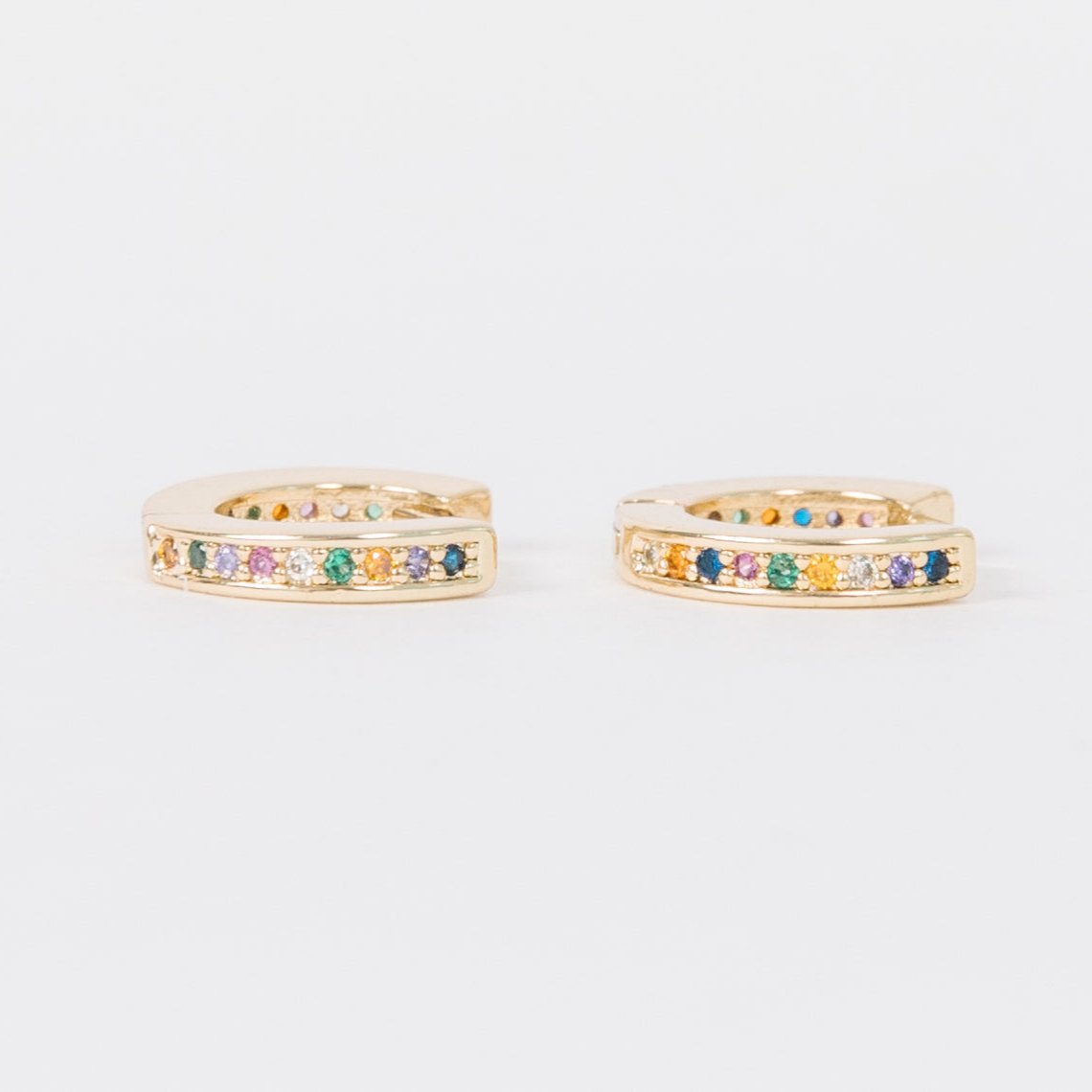 14k Gold Filled 12 mm huggie clasp Safe for sensitive skin Unique clasp has no post when earrings are closed, allowing for comfortable wear and sleep without having to remove earrings Multicolored bejeweld stones are 2 mm Perfect for mulitple piercings Freaking cute and freaking tiny